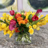 Bright color pops make this flower arrangement a joyful choice for exciting