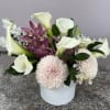 A serene blend of white calla lilies and pink orchids creates an