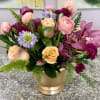 Blush, peach, magenta and lavender blooms mingle in a lush, rounded design