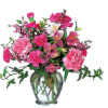 Pink mixed flower arrangement in a clear glass vase