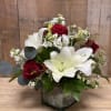 Red roses and white lilies arranged in a square vase