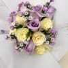 Bouquet of lavender and cream roses with small purple filler flowers
