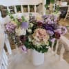 A purple lover's dream! This arrangement comes with assorted flowers in hues