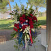 This Standing spray is designed in patriotic colors of red white and
