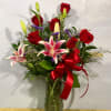 Half of a dozen of red roses arranged in a glass vase
