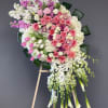 Large pink and white floral standing spray on an easel