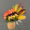 Bouquet of orange roses and yellow orchids in a striped vase