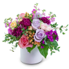 Mixed bouquet of roses and carnations in a white vase
