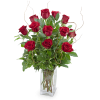 Red roses arranged in a clear glass vase