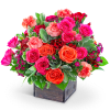 Mixed bouquet of pink and orange roses with carnations in a wooden box