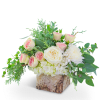Pink and white roses in a birch bark container