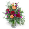 Bouquet of red and peach roses in a clear glass vase
