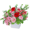 Pink and red flower arrangement in a white vase