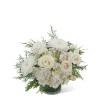 White roses and chrysanthemums in a glass vase with greenery
