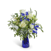 White roses and blue flowers in a cobalt glass vase