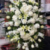 Large white floral spray with roses and lilies