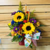 This colorful arrangement with sunflowers in a red container is perfect for
