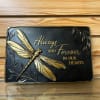 This black and golden stone features a dragonfly and a commemorating phrase:
"Always