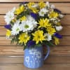 This sweet arrangement comes with yellow and white daisies, statice, and baby's