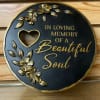 This black and gold plaque has floral detailing and a commemorating phrase:
"In