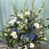 A stunning blue, classic-style funeral piece with soft blues and creams. Perfect
