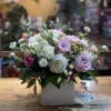 Bouquet of pink and white roses in a white square vase