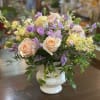 Pastel rose and lavender bouquet in a white vase