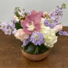 Pink orchid and pastel flowers in a copper bowl vase