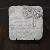 Decorative stone plaque with a tree and memorial quote