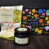 Gift set with a floral kitchen towel, edible flowers puzzle, and hand scrub jar
