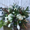 Large white floral arrangement with tulips, hydrangeas, and branches
