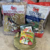 Bird food bags and suet cakes arranged on the floor