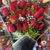 Beautiful front facing red rose bouquet wrapped in paper and accompanied with