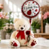 Teddy bear with a red ribbon holding an 