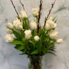 White tulips and roses in a clear glass vase