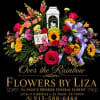 Colorful funeral floral spray with roses, sunflowers, and ribbon on a black background