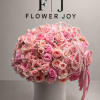 A grand arrangement of soft pink roses, blush spray roses, and cascading