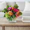 A vibrant gathering of peach roses, hot pink garden roses and immature