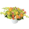 Bright mixed bouquet in a white vase with orange, yellow, and green flowers