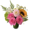 Bouquet of pink roses, a sunflower, and mixed white blooms in a glass vase