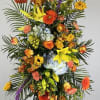 Tall standing floral spray with mixed bright flowers on a black easel