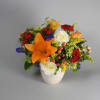 Orange lilies and white roses in a white vase