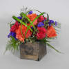 Mixed roses in a wooden box with green decorative loops