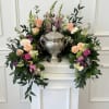 This cremation urn arrangement is designed to surround the urn with an