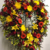 Heart-shaped floral wreath with red, yellow, and orange blooms