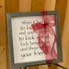 Framed quote sign with a pink ribbon bow