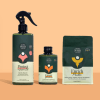 Three plant care products in dark green packaging on a peach background
