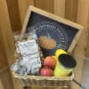 Basket of apples, candy, and a candle with a pumpkin patch sign