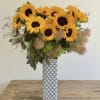This arrangement is bright, cheerful, and effortlessly elegant. Golden sunflowers take center