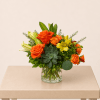 Orange and yellow mixed bouquet in a clear glass vase